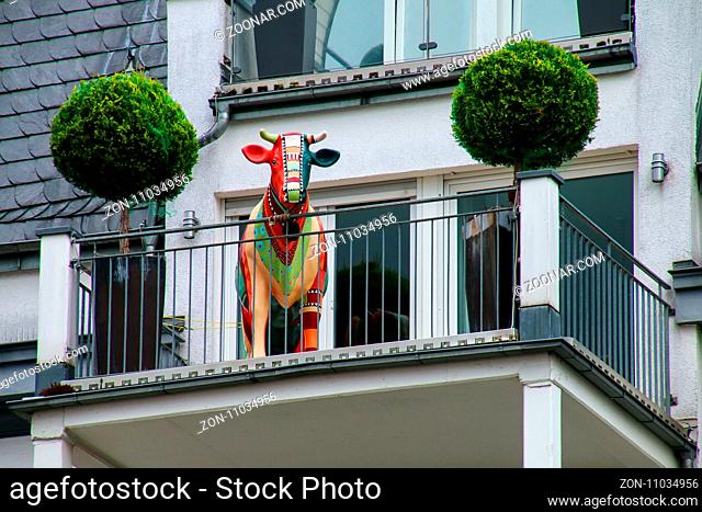 Detail of a residential building with cow statue on the balcony, Wiesbaden, Hesse, Germany. Wiesbaden is one of the oldest spa towns in Europe