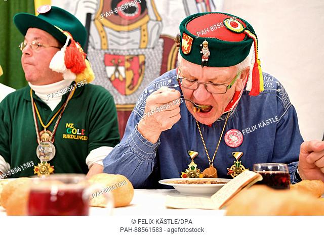 Prime Minister of Baden-Wuerttemberg Winfried Kretschmann (The Greens, r.) can be seen dressed up in a jester costume taking part a culinary event in the town...