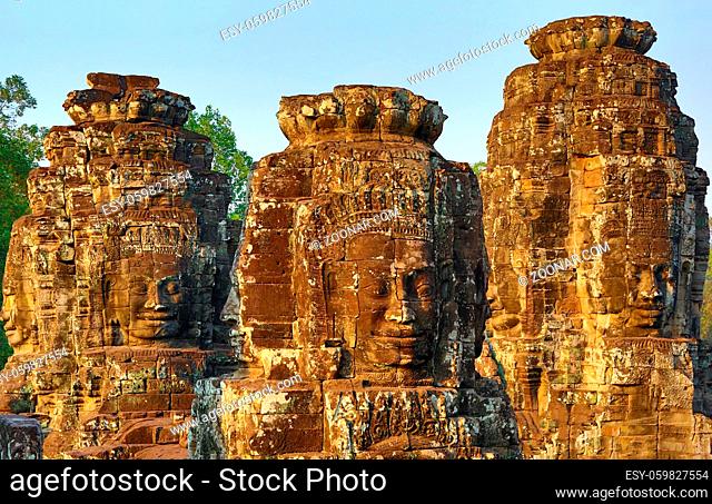 Giant stone faces at Bayon Temple at sunset, Angkor Wat, Cambodia
