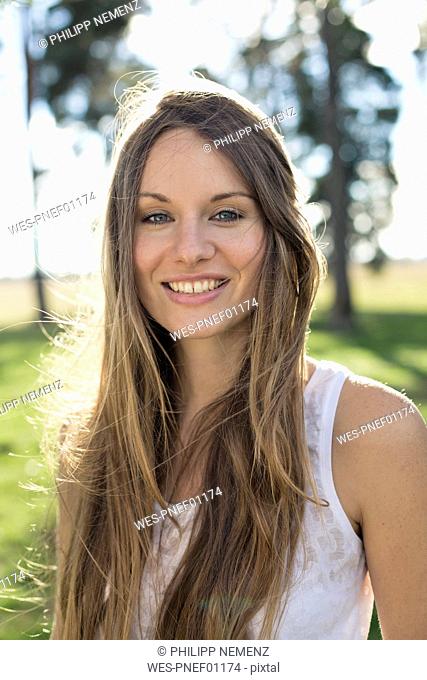 Portrait of smiling young woman in nature