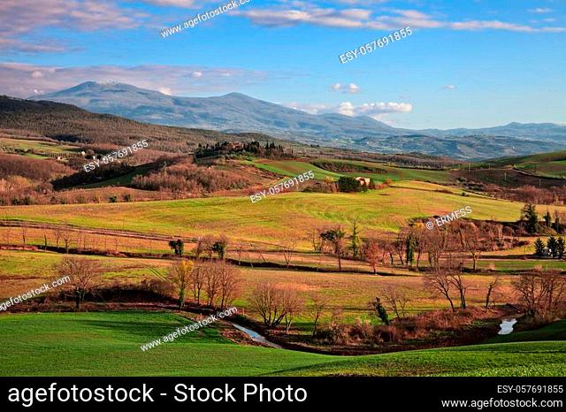 Val d'Orcia, Siena, Tuscany, Italy: spring landscape at sunset of the countryside, the colorful hills and the Mount Amiata on background