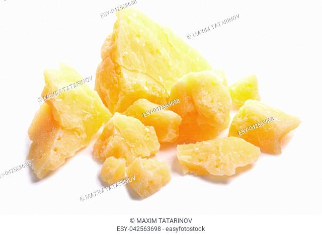 Pile of hard grainy mature cheese (Parmesan, Parmigiano), rough pieces. Clipping paths, shadow separated