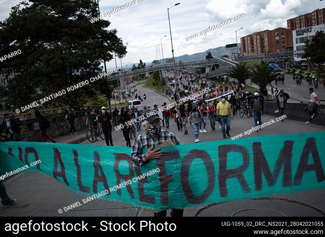 Demonstrators hold a sign with the message ""No to the reform"" as demonstrations rise against the tributary reform of president Ivan Duque on April 28, 2021