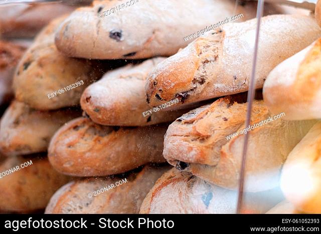 stack of fresh baguette bread closeup for sale at bakery