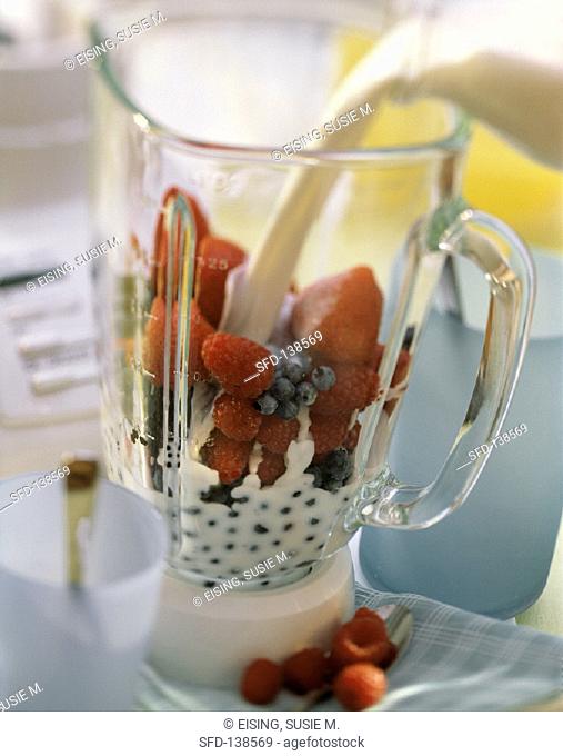 Making berry milkshake: placing ingredients in measuring jug (2)
