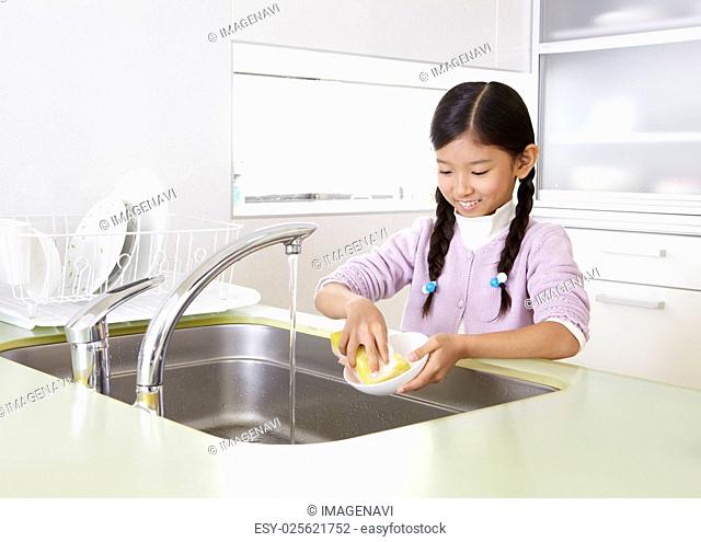 Girl washing dishes