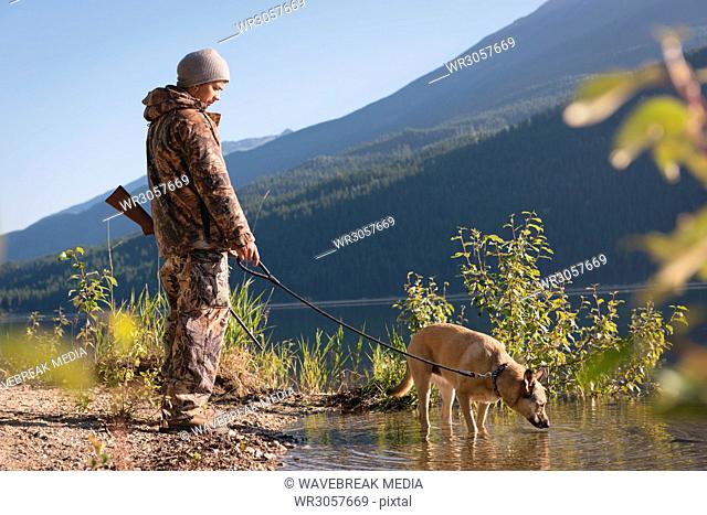 Hunter with his dog resting during the hunt