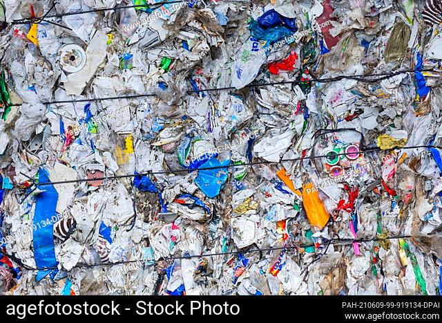 08 June 2021, North Rhine-Westphalia, Erftstadt: Sorted packaging waste stands pressed next to a hall after it has been separated in the sorting plant of the...