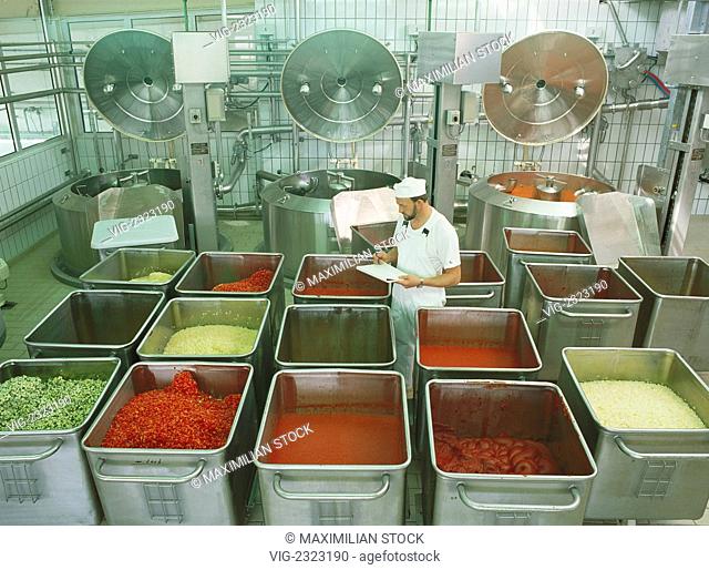 Soup factory. Worker checking vehicles with portioned foodstuffs for production of soups and sauces, - 01/01/2010