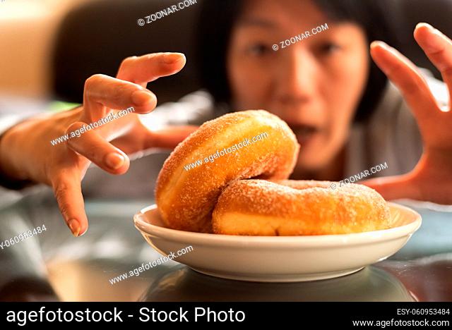 Asian woman want to eat donut at home