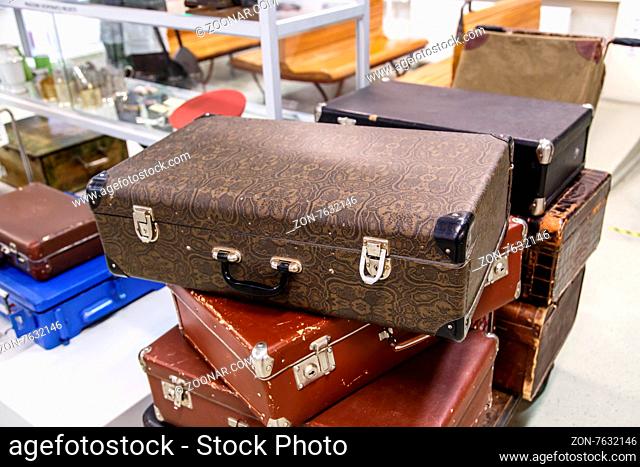 View of old nostalgical brown leather and fabric suitcases on end