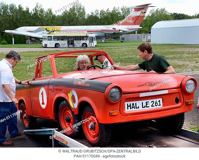 Rolf Becker (C) brings a Trabant car, which runs on manure, to the Aviation and Technology Museum in Merseburg, Germany, 16 August 2014