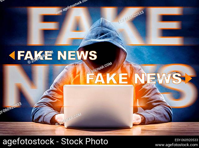 hacker on a computer spreading fake news