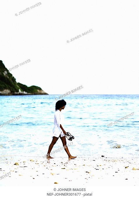 A woman walking on a beach