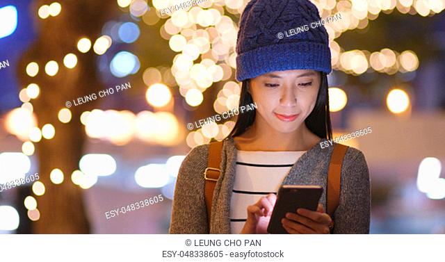 Woman use of mobile phone in winter