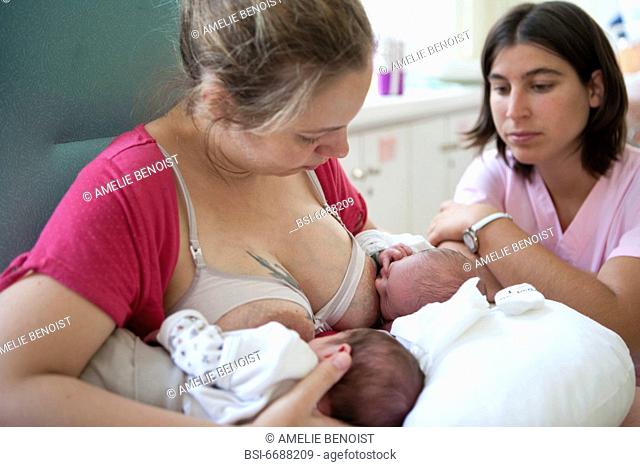 Photo essay at the maternity of the Diaconesses hospital in the 12th district of Paris, France. The midwife is showing the mother how to do a simultaneous...