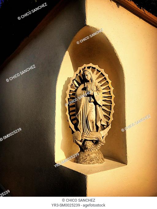 A sculpture of Our Lady of Guadalupe decorates a house in Coyoacan, Mexico City, Mexico