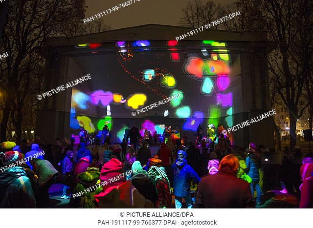 16 November 2019, Latvia, Riga: Video projection on a stage in a park. Latvia's capital Riga presents itself on the occasion of the national holiday on 18...