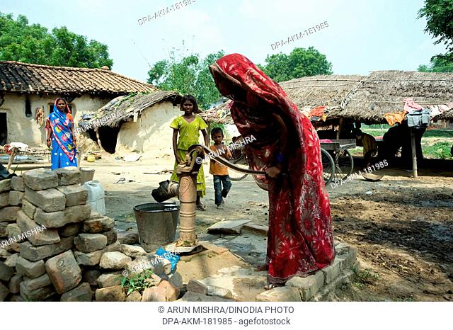 Woman pumping water from borewell Varanasi uttar pradesh India Asia
