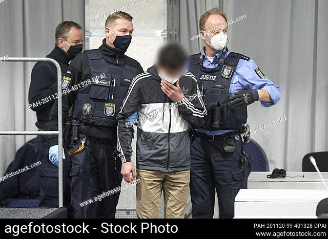 20 November 2020, Hessen, Limburg: The accused is led into the courtroom, which is provisionally set up in a marquee. He is accused of attempted murder
