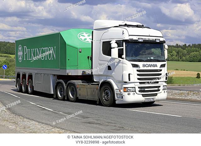 White Scania R560 truck and Pilkinton glass transport trailer on road intersection on a day of summer in Salo, Finland - June 2, 2018