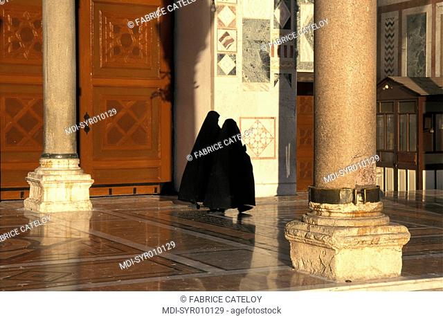 Veiled women in the religious courtyard or sahn of the Umayyad Mosque