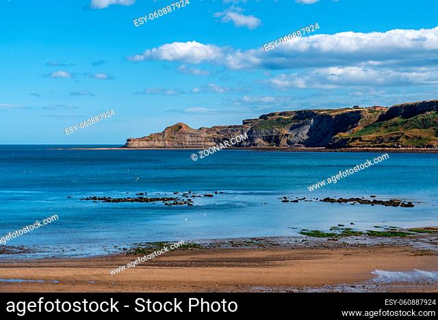 North Sea Coast in North Yorkshire, England, UK - looking from Runswick Bay towards the former quarry in Kettleness Point