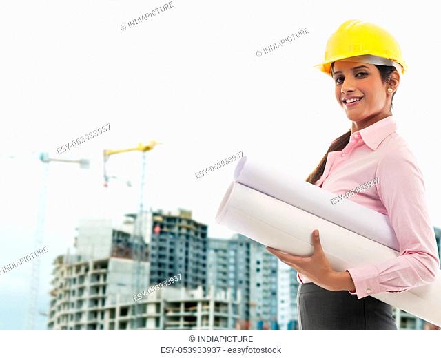 Female engineer with blueprints