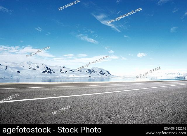 empty asphalt road with snow mountain