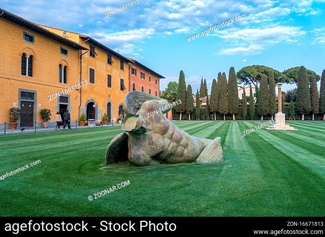 PISA, TUSCANY/ITALY - APRIL 17 : Fallen Angel at the Square of Miracles in Pisa Tuscany Italy on April 17, 2019. Three unidentified people