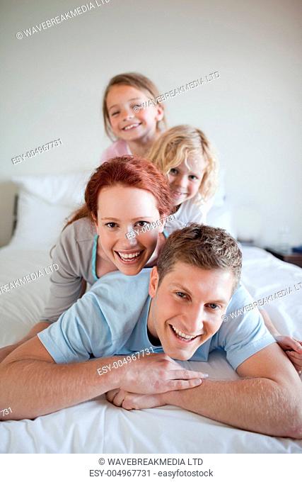 Family having fun on the bed