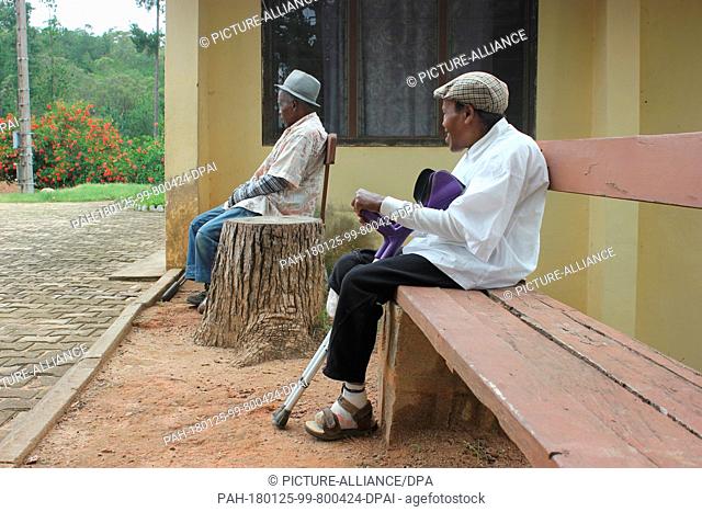 Men sit in the leprosy centre in Marana, Madagascar, 23 January 2018. Many older still live after their recovery in the centre since they were outcasted by...