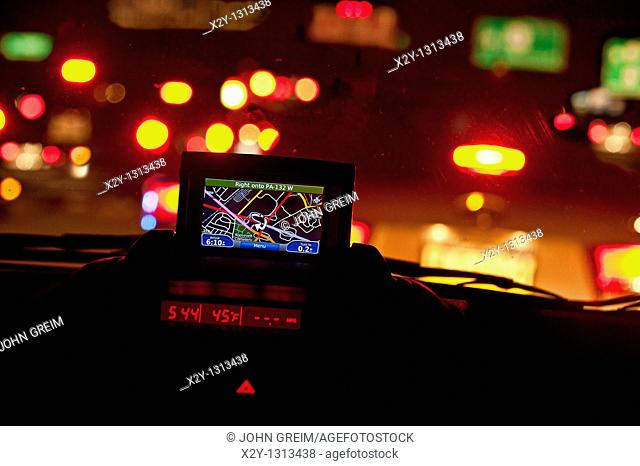GPS unit in the window of a car in traffic