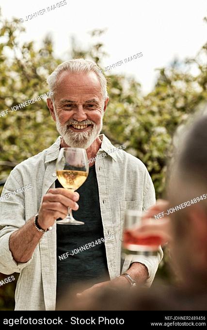 Happy man having glass of wine