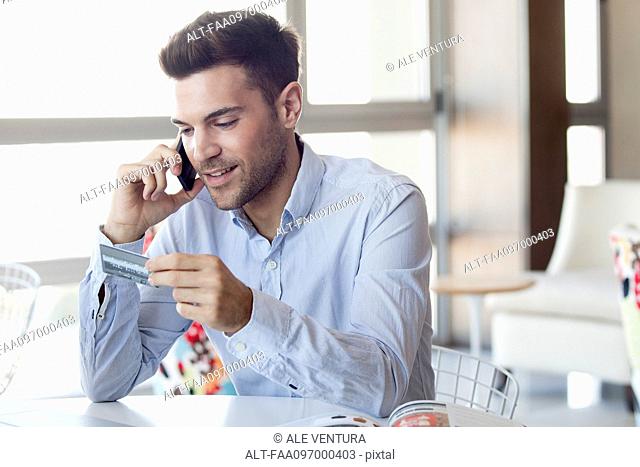 Man making credit card purchase over the phone