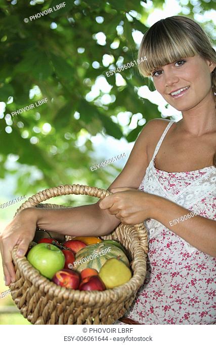 Young woman with a basket of fruit