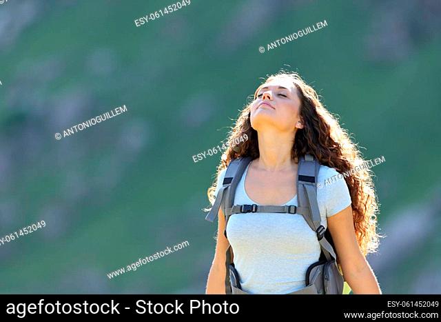 Backpacker relaxing in the mountain breathing fresh air