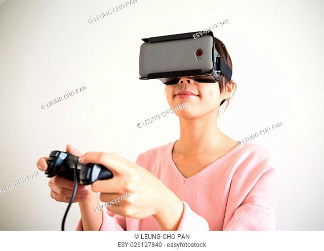 Asian Woman play game with virtual reality device