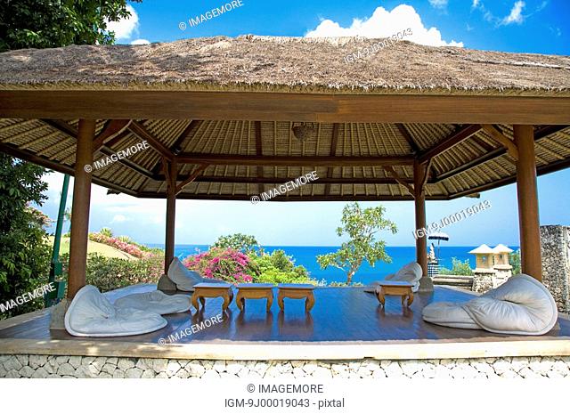 Bali, a thatched-roof pavilion by sea