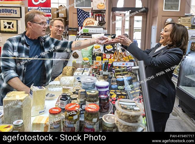 United States Vice President Kamala Harris, right, samples some cheese prior to making a purchase at Bowers Fancy Dairy Products Stand No