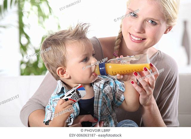 portrait of a woman feeding her son
