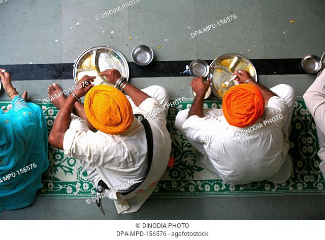 300th year of consecration of Guru Granth Sahib on 30th October 2008 ; Sikh devotees having food at a Langar (traditional community kitchen) at Sachkhand Saheb...