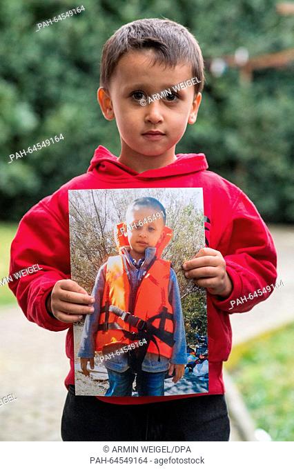 The Syrian refugee child Mohamed is showing a photo of his journey in a life jacket in the Mediterranean, now in Mangolding, Germany, 09 December 2015