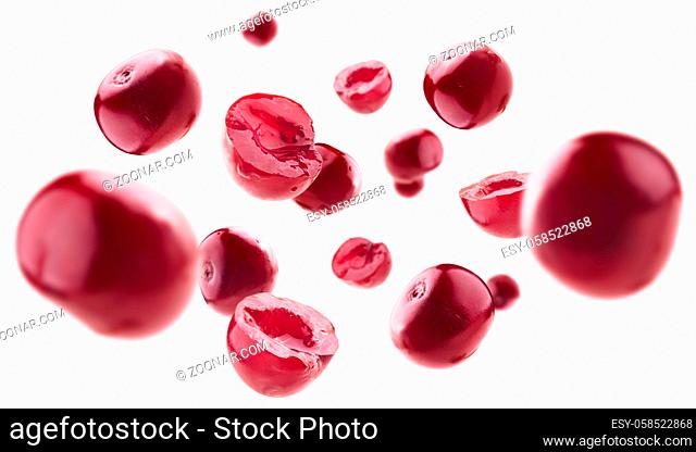 Red cherry berries levitate on a white background