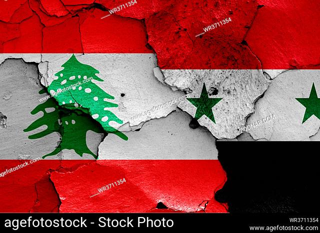 flags of Lebanon and Syria painted on cracked wall