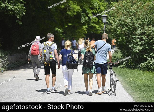 Public life in times of the coronavirus pandemic in the English Garden in Munich. Recreational athletes, joggers, cyclists, walkers in the park
