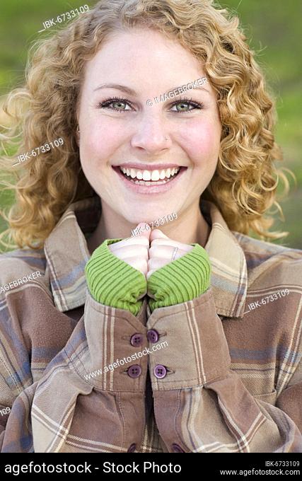 Pretty young smiling woman outdoor portrait