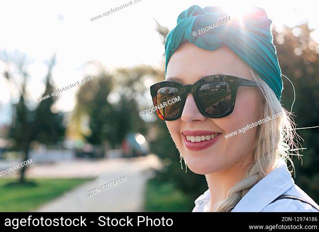 Beautiful young girl posing with turban, spring time
