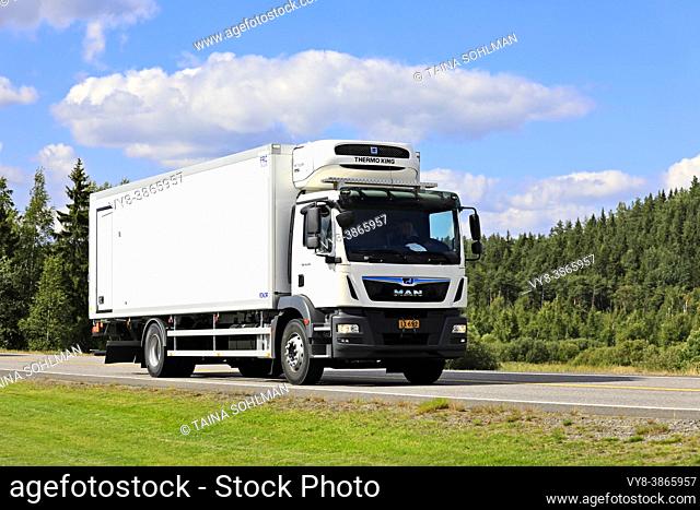 White MAN TGM 18. 290 truck in front of FRC Thermo King refrigerated trailer on Highway 2 on beautiful day of summer. Forssa, Finland. August 21, 2020