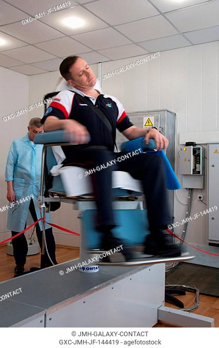 At the Cosmonaut Hotel crew quarters in Baikonur, Kazakhstan, Expedition 51 crewmember Jack Fischer of NASA takes a spin in a rotating chair to test his...
